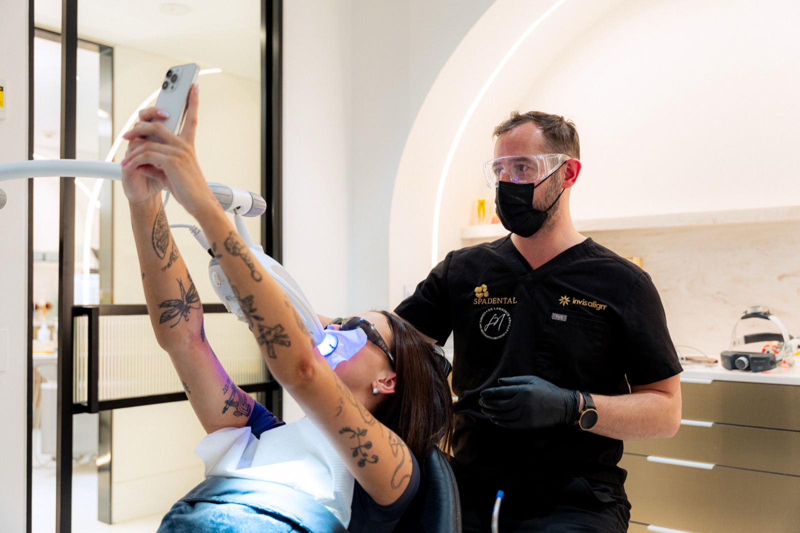 A patient photographing her smile mid-appointment