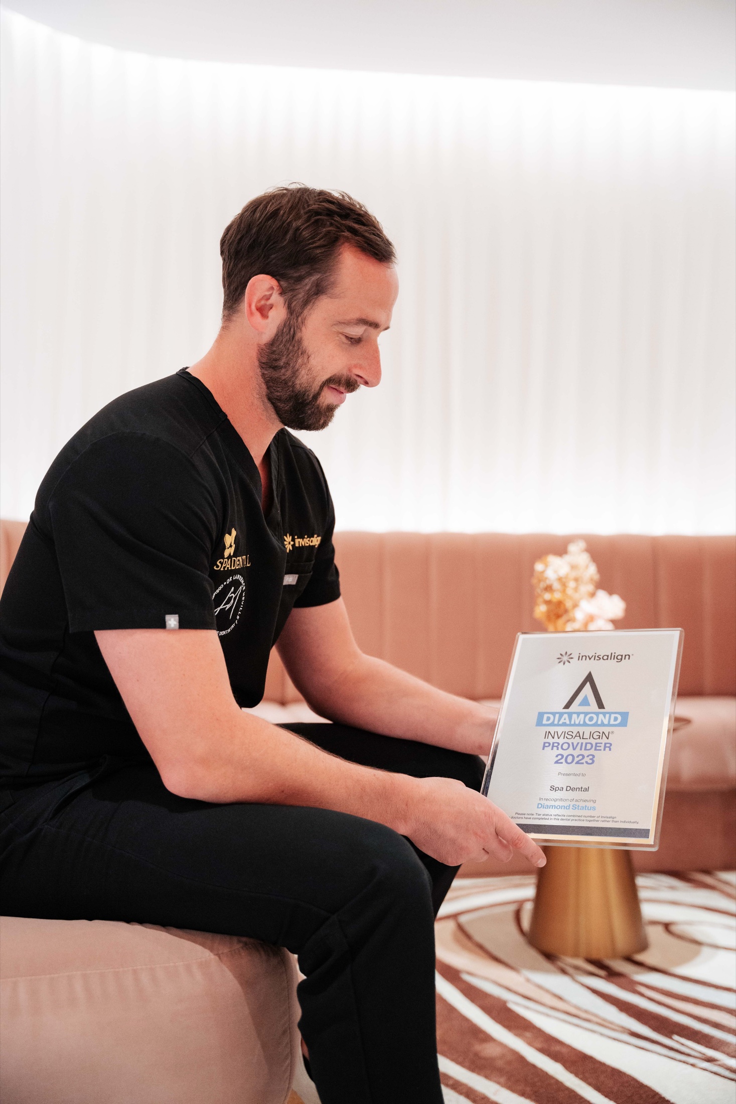 A Spa Dental dentist with the practice's Invisalign Diamond Provider 2023 plaque