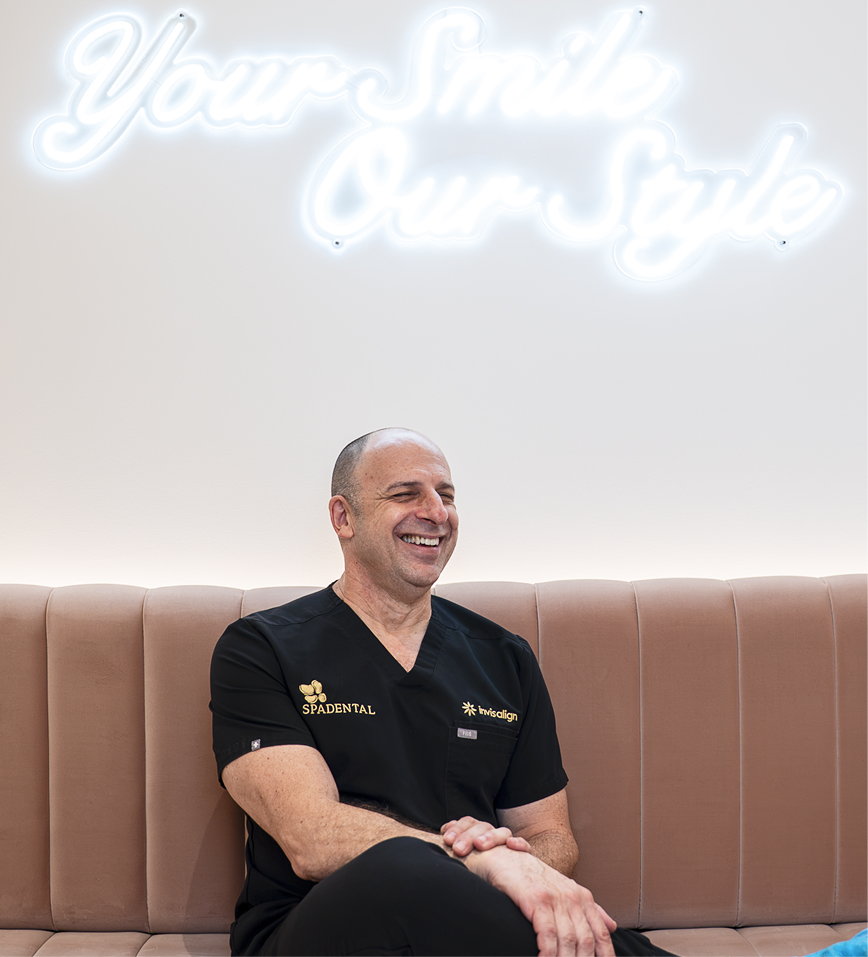 A Spa Dental dentist in the lounge beneath the neon sign
