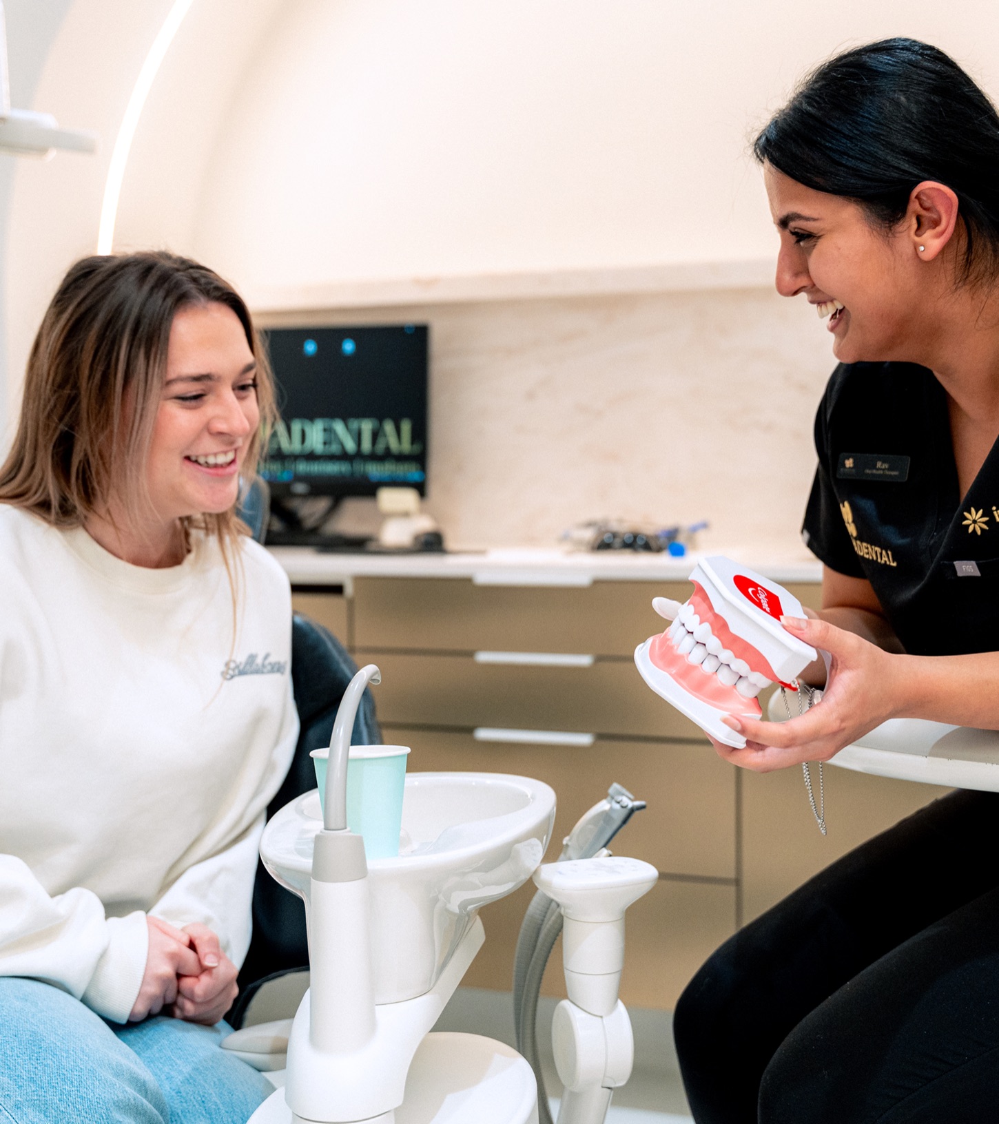 A clinician and a smiling patient chatting during a relaxed consultation
