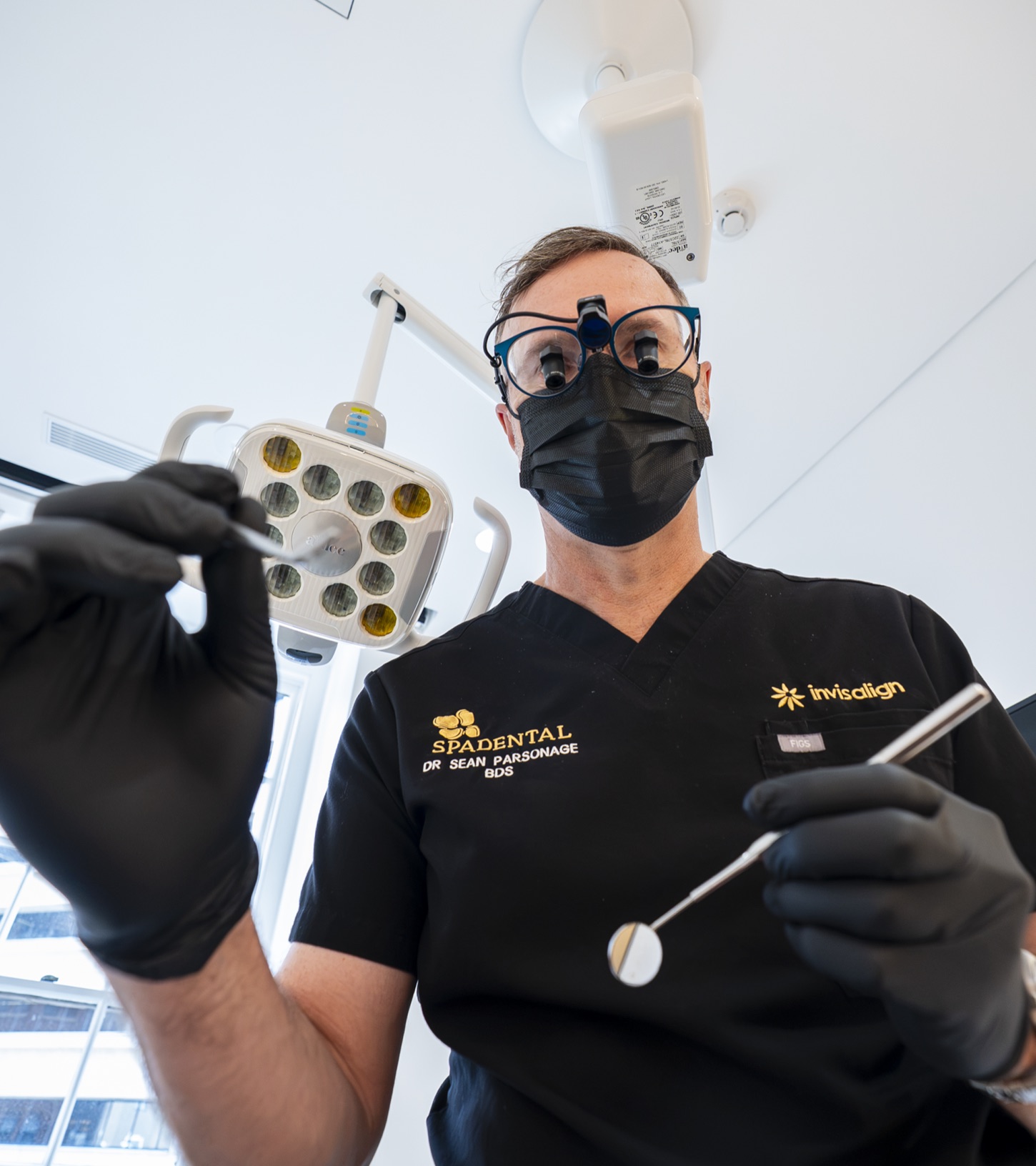 A Spa Dental dentist in loupes at work in the surgery