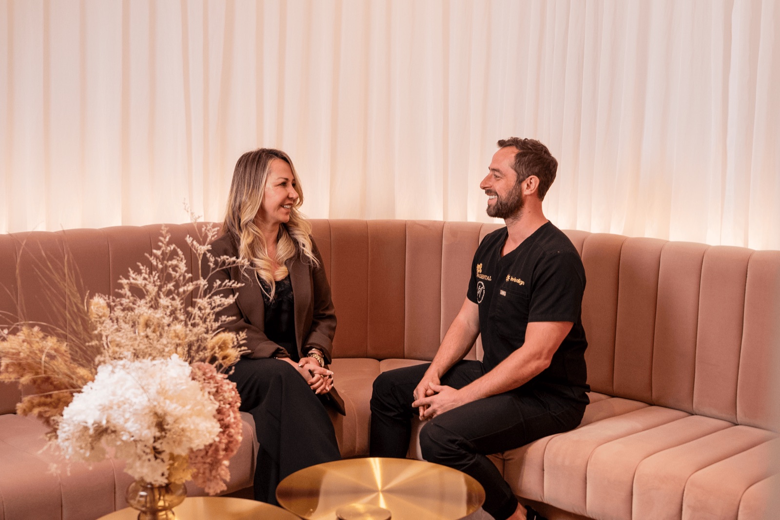 A patient and their Spa Dental dentist talking on the clinic's lounge