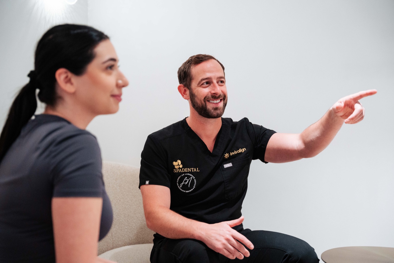 A Spa Dental dentist talking with a patient in the lounge