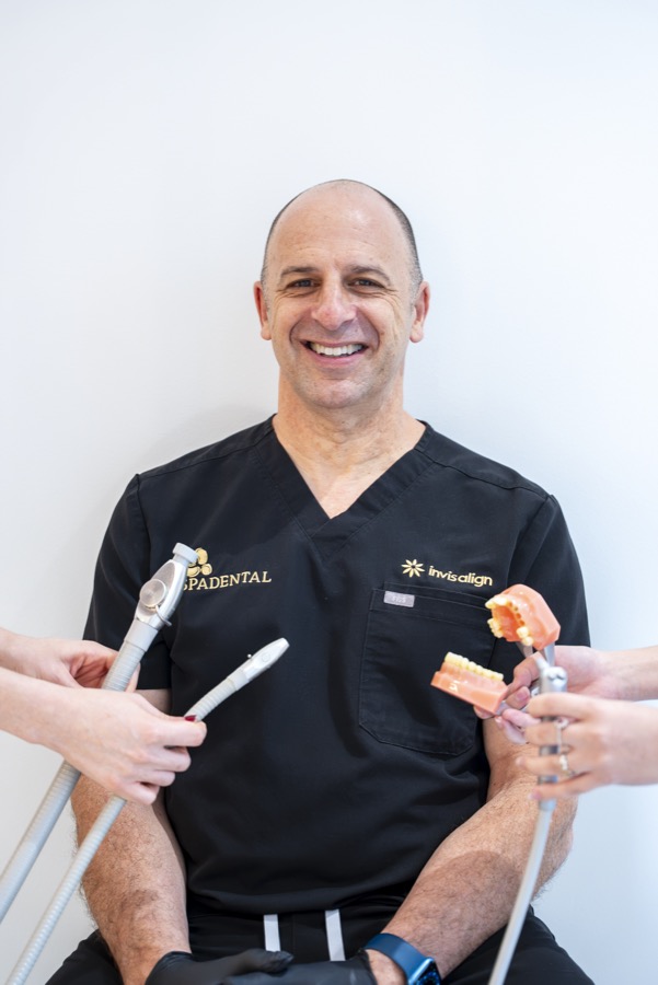 Spa Dental dentist with Invisalign aligners and a study model