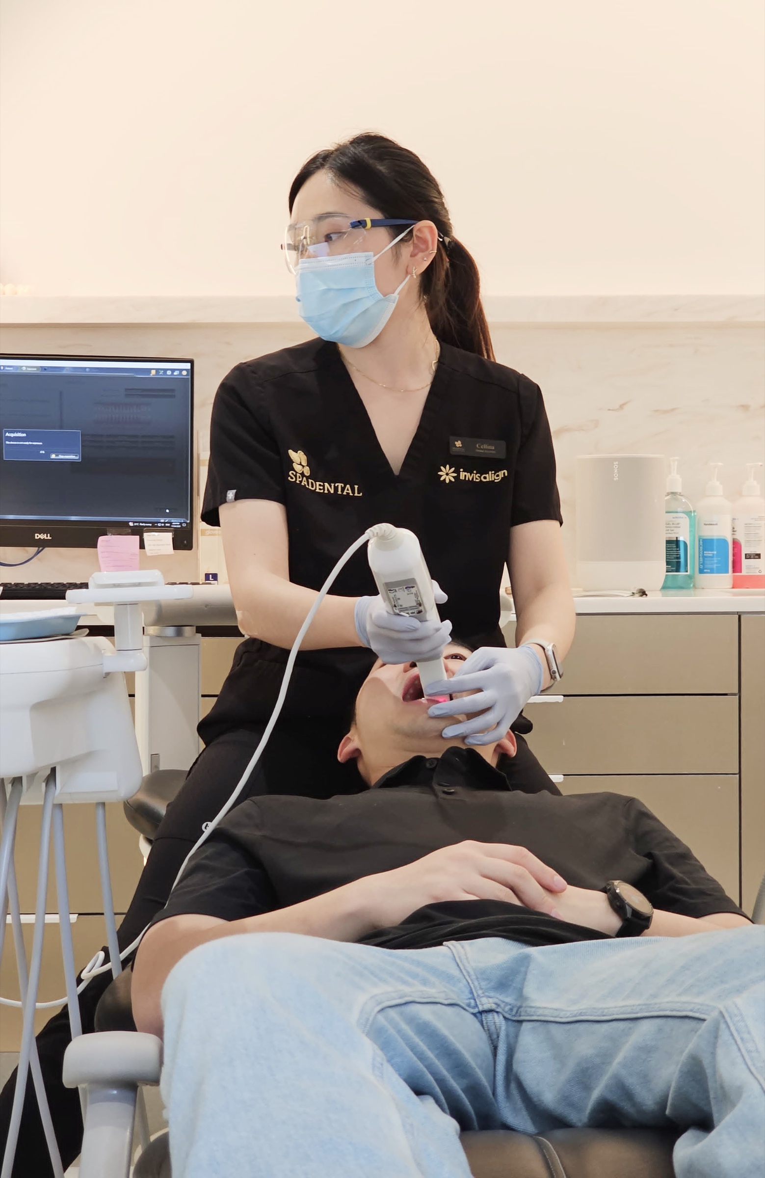 A cosmetic dentist assessing tooth shade at Spa Dental